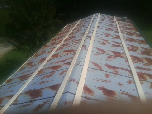 Rusted metal roof panels with new wood purlins before replacement — Storm Damage Roof Repair in Rienzi by Roofing Brothers